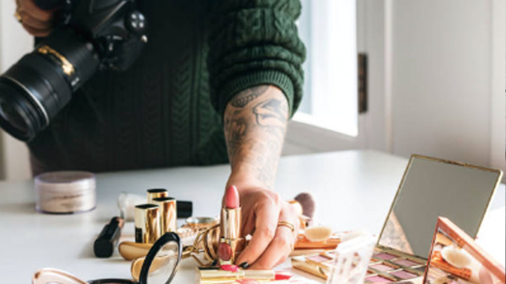 Beauty blogger taking photo of cosmetics.