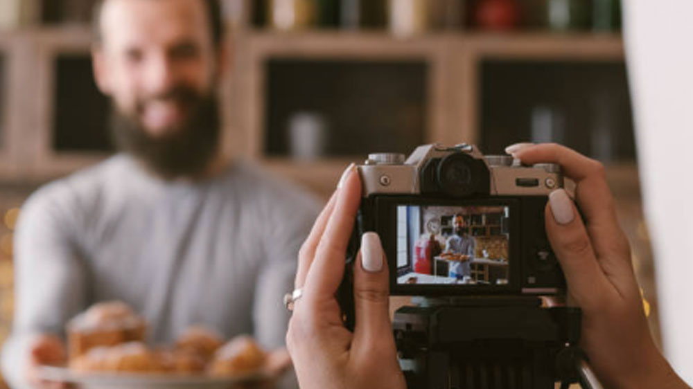 food blogging business couple lifestyle pastries Food blogging business. Couple lifestyle. Woman shooting man with fresh homemade pastries assortment